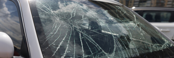 Closeup of cracks on broken car windshield