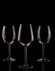 wine glass on black background. Set of empty crystal wine glasses, with black background and transparent tones.