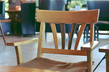 Wooden chair with seat cushion at restaurant. Selective focus.