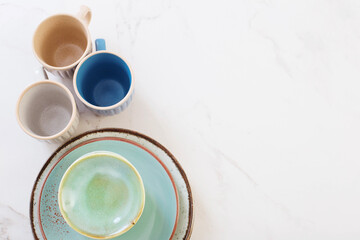 ceramic cups and plates on white marble table