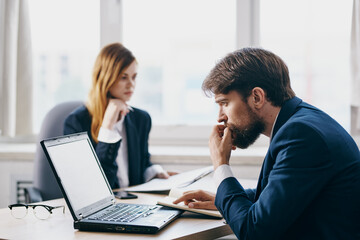 colleagues sitting in front of a laptop teamwork internet technologies