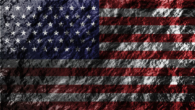 USA national flag painted on shiny big rock. 