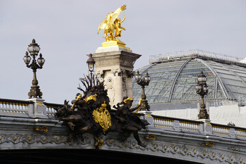 Obraz premium view of pont alexandre iii with carved sculptures alongside, lamp post and glass building downtown paris france