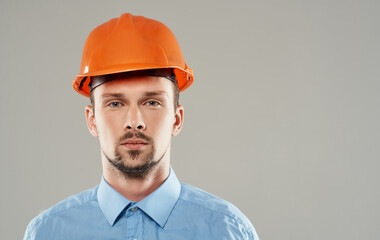 male builder in a blue shirt emotions professional isolated background