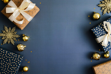 Christmas frame. Blue Xmas background with gift boxes, golden snowflakes and baubles. Christmas frame, greeting card template, banner mockup. Flat lay, top view, copy space