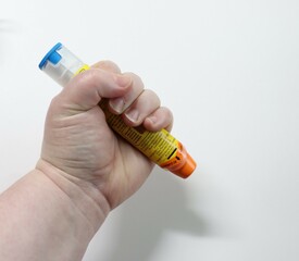 hand holding an Epipen