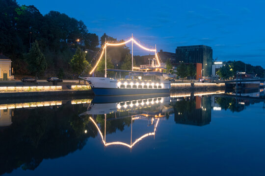 Turku, Finland - August 5, 2021: Illuminated Cindy ship on Aurajoki river at night.