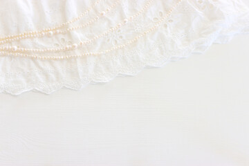 Background of white delicate lace fabric and pearls