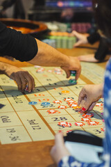 Obraz premium Players place bets in the casino. Game table with chips closeup.