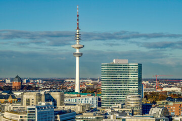 Bird's eye view of the television tower of Hamburg with the surrounding city and blue sky
