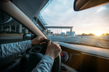 Fototapeta premium People driving car on sunrise city road .