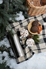 Winter picnic in the forest. Picnic basket in the snow. Winter holidays	