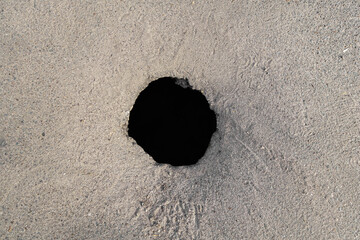Top view of a hole in the asphalt pavement © Poliorketes