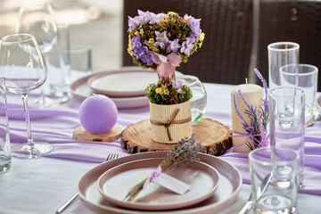 Beautiful floral arrangement and candles on wedding table in restaurant, copy space. Luxury wedding decorations