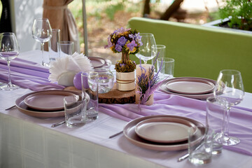 Beautiful floral arrangement and candles on wedding table in restaurant, copy space. Luxury wedding decorations