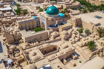 Historical buildings of Khiva (Uzbekistan) from above. Building with green dome is mausoleum of...