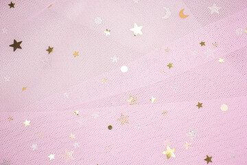 Light pink Crumpled festive tulle fabric (pink, purple, delicate) with sequins in the form of stars drapes beautifully. texture of wedding clothes, veil, dress, skirt.