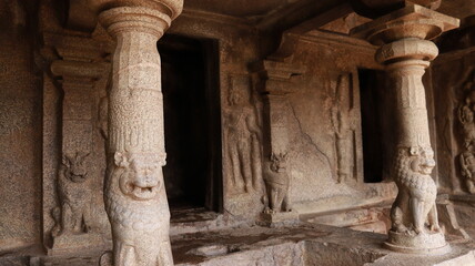 Mahishasuramartini Cave Temple. The pillar carved in the rock is located in the background of the cave temple