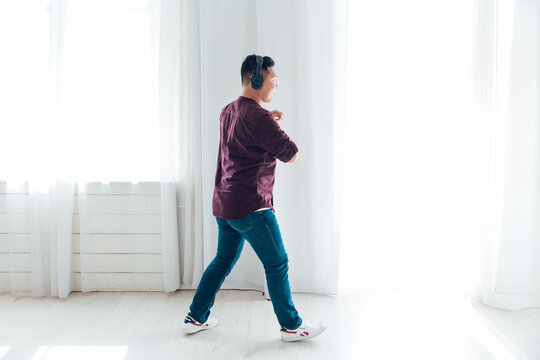 Asian Man Dancing To Music Alone At Home