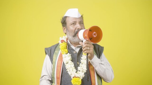 Politician with Flower Garland giving public speech using megaphone for asking vote while Election campaign Concept of Fake political announcement
