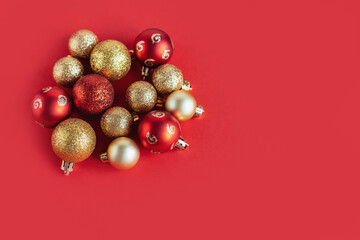 Red and golden christmas ornaments on a red background. Christmas background.