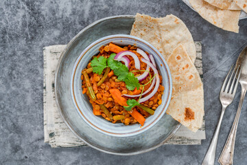 Vegan green lentil curry with paratha flatbread