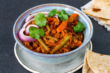 Vegan green lentil curry with paratha flatbread