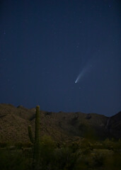 USA, Arizona, Buckeye. Comet Neowise spews trail over White Tank Mountains and desert.