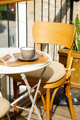 Cup of aromatic coffee cappuccino or latte on a wooden table. Concept of meeting or relaxing. Tasty morning drinks.