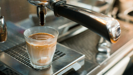 black coffee with milk on a coffee maker