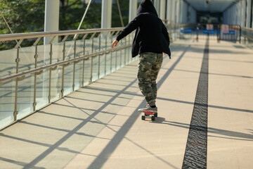 Skateboarder legs riding skateboard at city
