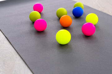 Colored Myofascial release massage balls on gray mat. View on top