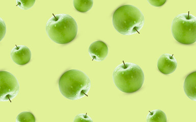Seamless pattern from green apples on a yellow background.