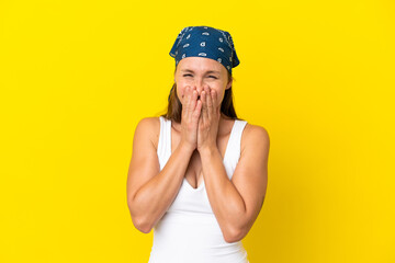 Young English woman isolated on yellow background happy and smiling covering mouth with hands