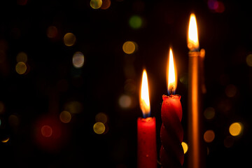 Burning Christmas candles on a dark background