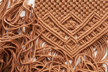Handmade macrame pattern close up. Macrame braiding and cotton threads on wooden table.  Female hobby.  ECO friendly modern knitting DIY natural decoration  - obrazy, fototapety, plakaty