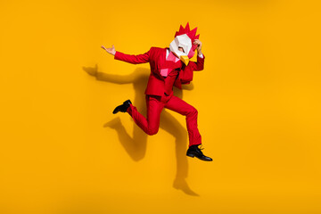 Fototapeta na wymiar Photo of carefree model guy absurd jump wear cock polygonal mask red tux shoes isolated yellow color background