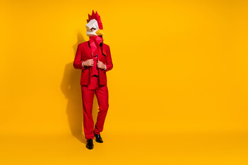 Photo of luxury agent prepare event outfit wear chicken polygonal mask red tux isolated yellow...