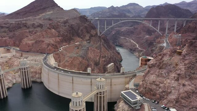 Orbiting aerial view of the Hoover Dam with the Mike O'Callaghan&ndash;Pat Tillman Memorial Bridge in sight. 