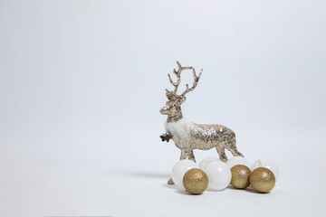 Silver deer, reindeer and golden New Year's decoration on a white background. Christmas and holiday concept.