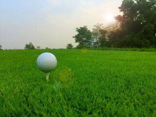 golf ball on tee in a beautiful golf course with morning sunshine.Ready for golf in the first short.Sports that people around the world play during the holidays for health.