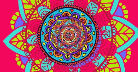 Close-up of colorful psychedelic mandala rangoli pattern on pink background
