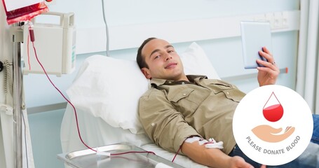 Portrait of smiling male donor lying with digital tablet on bed during blood donation at hospital