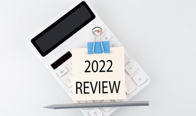 2022 REVIEW text on the sticker on white calculator