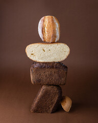 Different types of bread lie on top of each other on a brown background