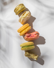 Macarons of different colors on a light background