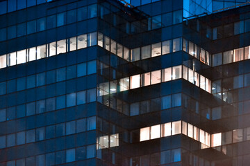 Modern glass office building at night - close-up