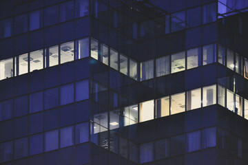 Modern glass office building at night - close-up