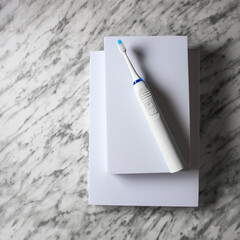 Top view of  ultrasonic toothbrush on white podium on marble background b