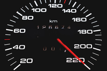 Car speedometer. Auto car speedometer shows 220 km h or miles.Closeup shot,dark black...